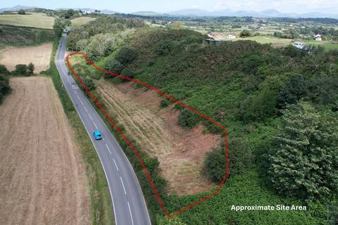 Land, in Land South Of Caernarfon Road, £100,000