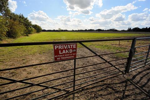 Land, in Ridding Lane, £60,000