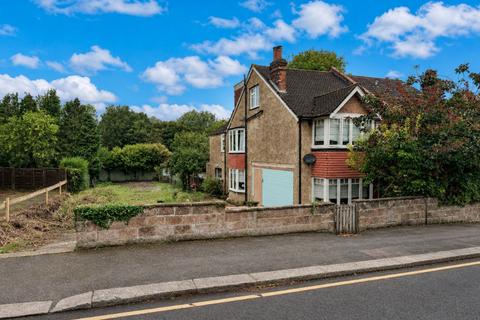 Land, in Reddown Road, £300,000