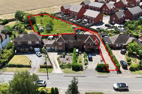 Land, in Village Street, £300,000