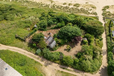 Land, in Manor Road, £100,000